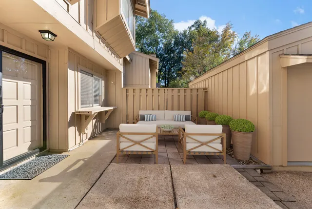 a backyard of a house with outdoor seating