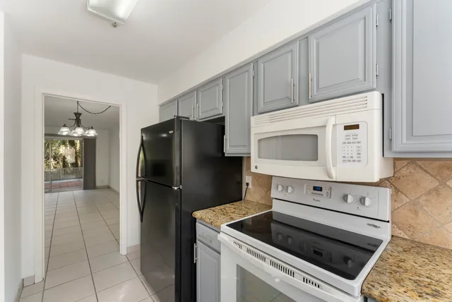 a kitchen with a refrigerator stove and cabinets