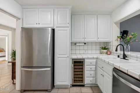 a kitchen with stainless steel appliances granite countertop white cabinets and a granite counter tops