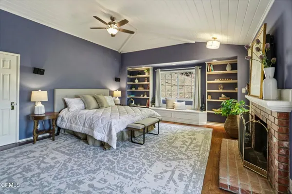 a bed room with a bed window and a fireplace