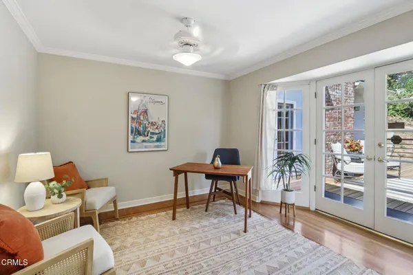 a living room with furniture and large windows