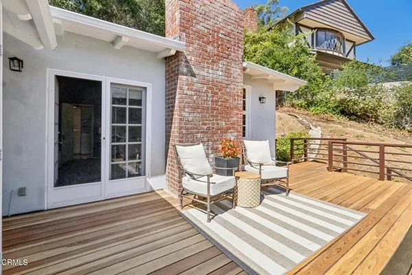a view of a roof deck with wooden floor and fence