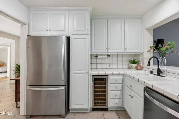a kitchen with appliances a refrigerator and a sink