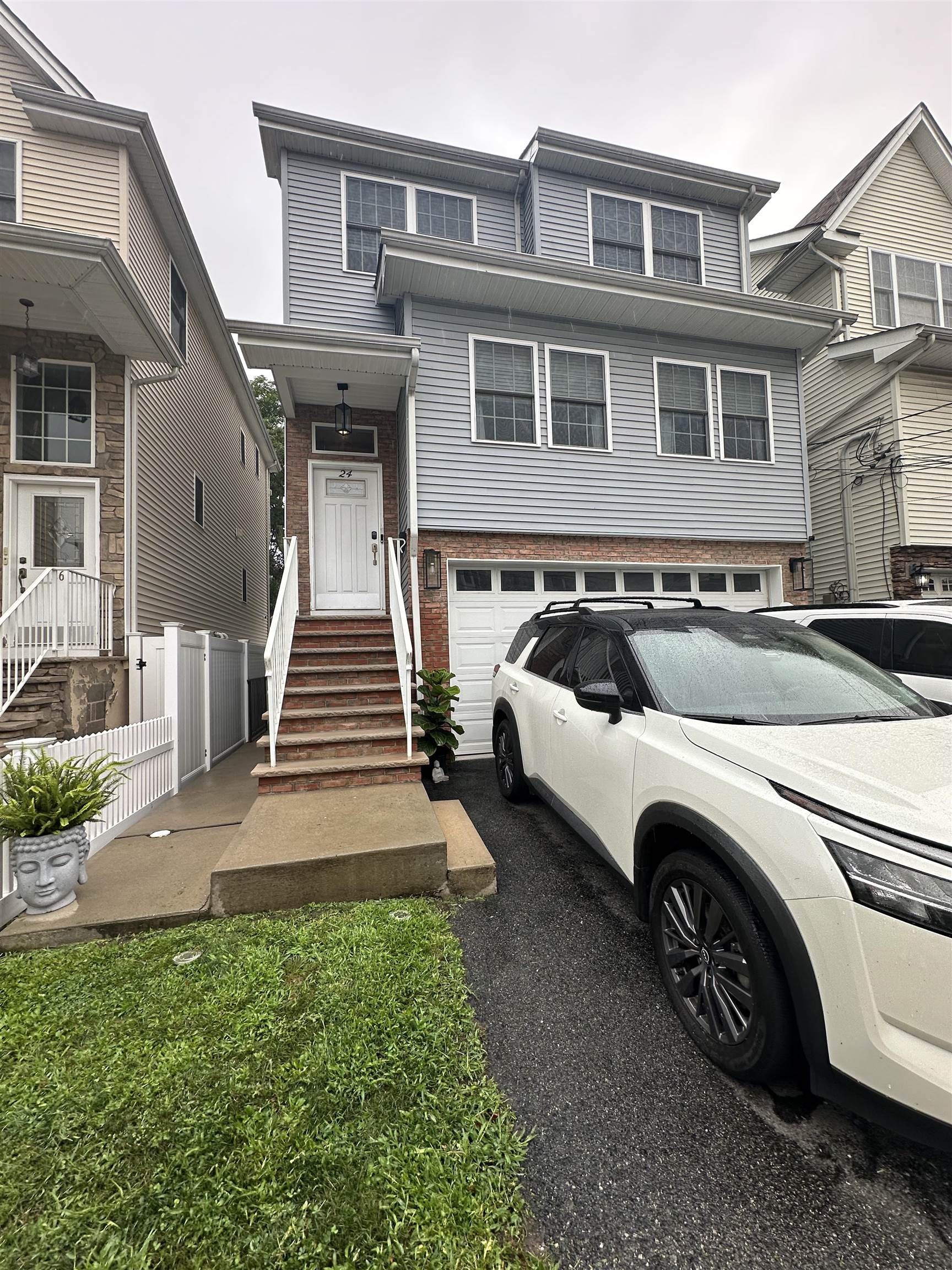 24 New Street, Unit 2 Bayonne, NJ 07002 - Photo 1 of 21 a front view of a house with a yard