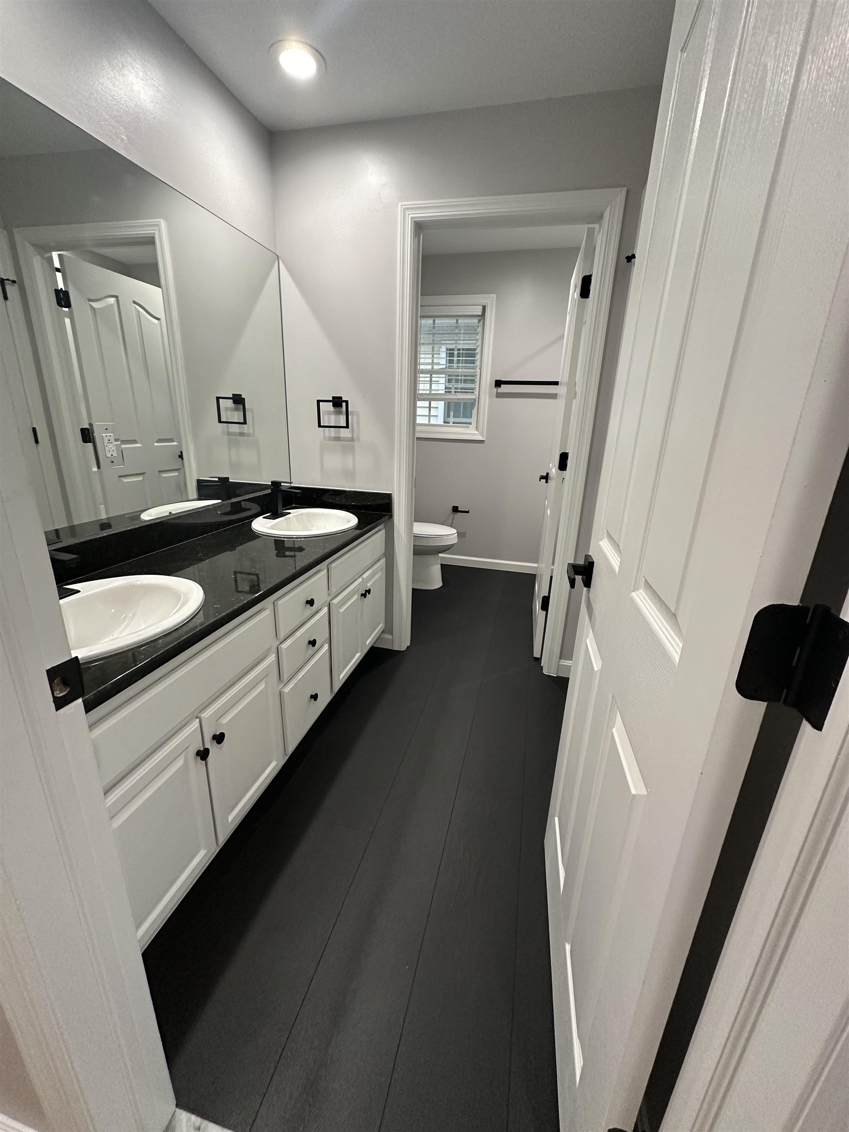 24 New Street, Unit 2 Bayonne, NJ 07002 - Photo 12 of 21 a bathroom with a double vanity sink and mirror with bathtub