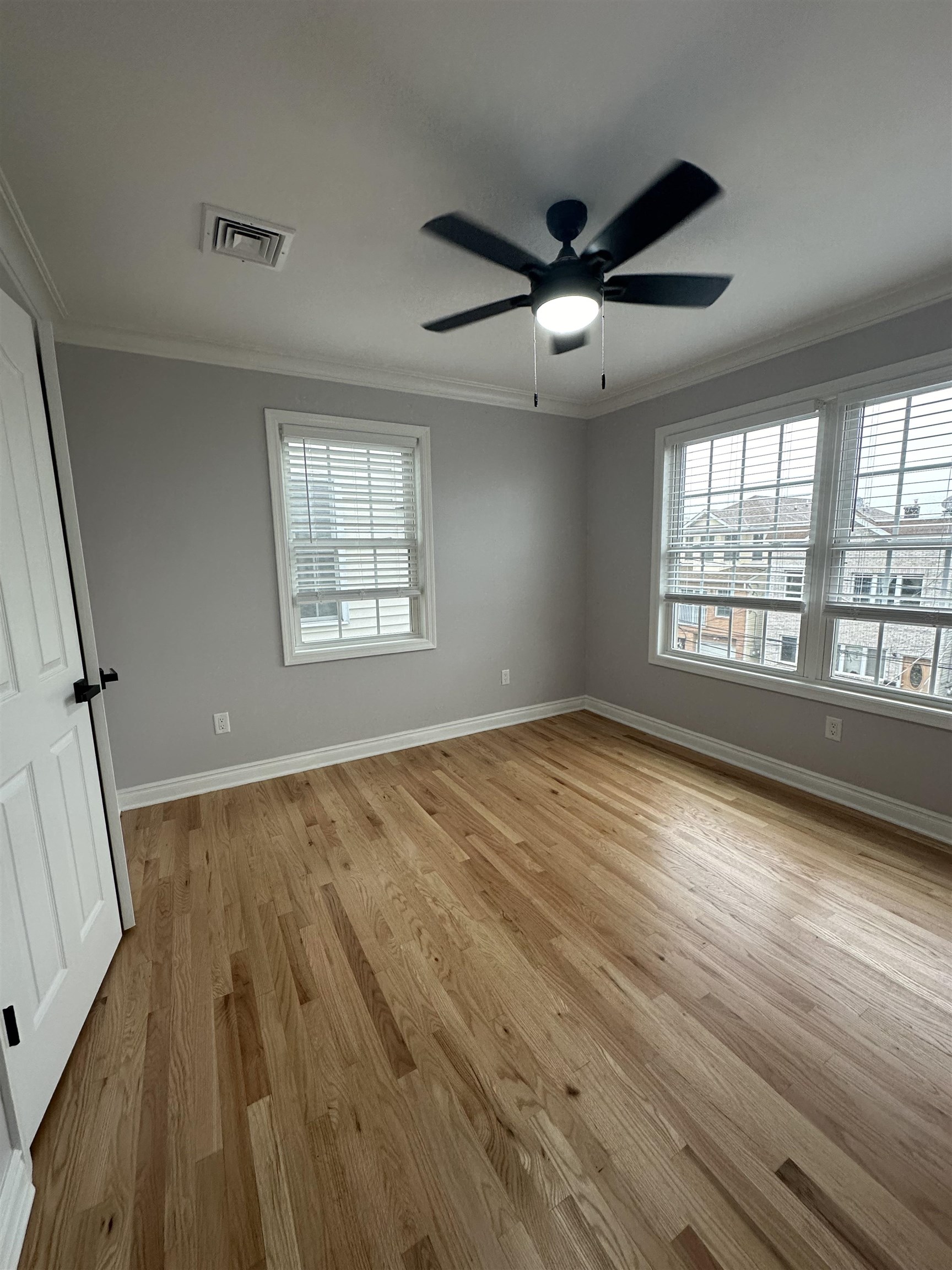 24 New Street, Unit 2 Bayonne, NJ 07002 - Photo 16 of 21 wooden floor in an empty room with a window