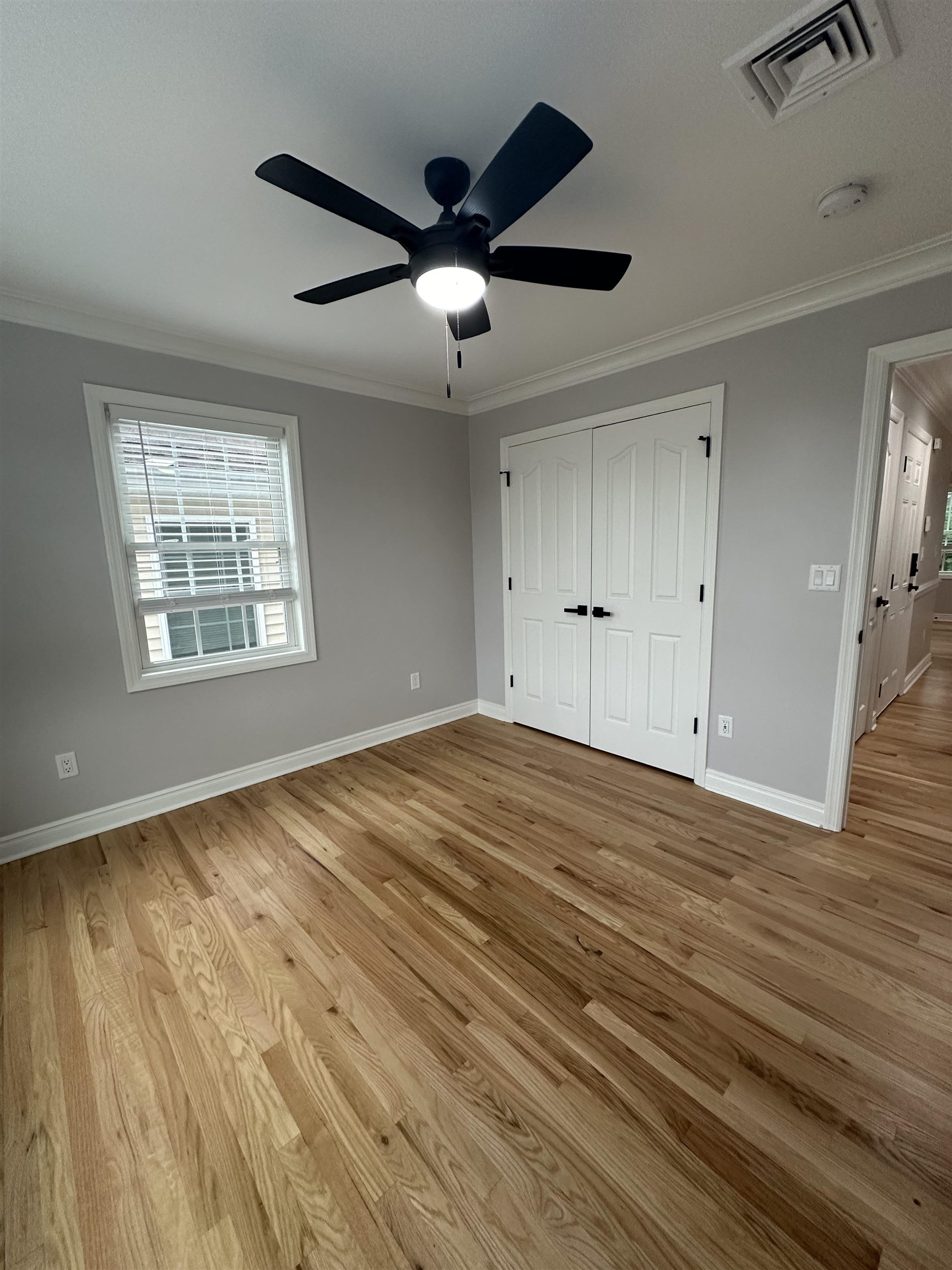 24 New Street, Unit 2 Bayonne, NJ 07002 - Photo 17 of 21 a view of empty room with wooden floor and fan