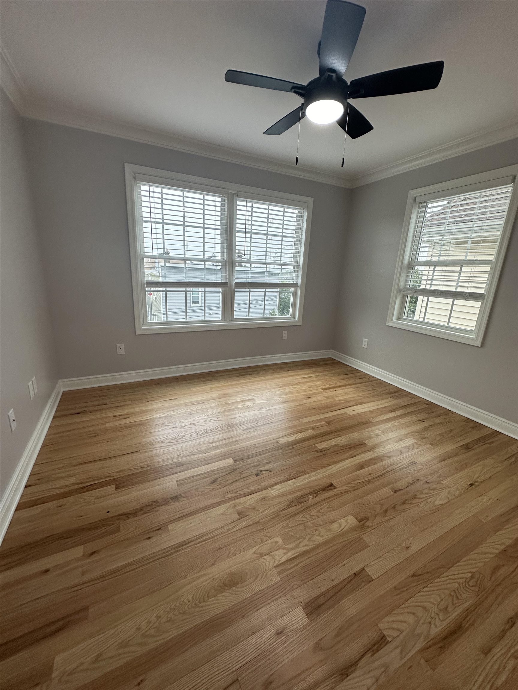 24 New Street, Unit 2 Bayonne, NJ 07002 - Photo 20 of 21 a view of an empty room with wooden floor and a window