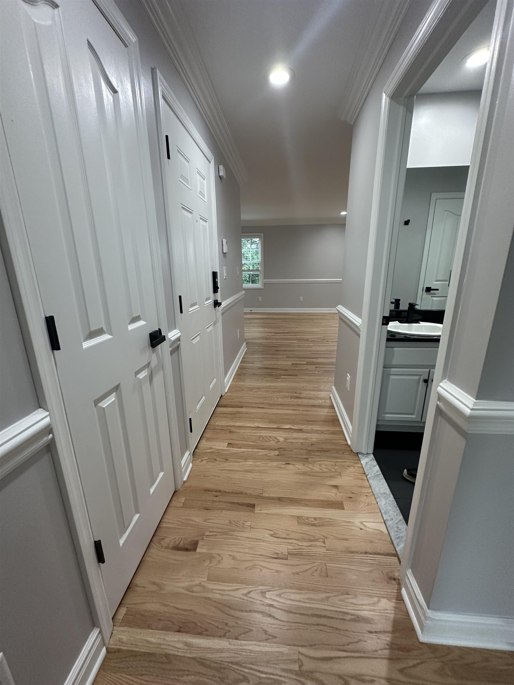 24 New Street, Unit 2 Bayonne, NJ 07002 - Photo 4 of 21 a view of a hallway with wooden floor and staircase