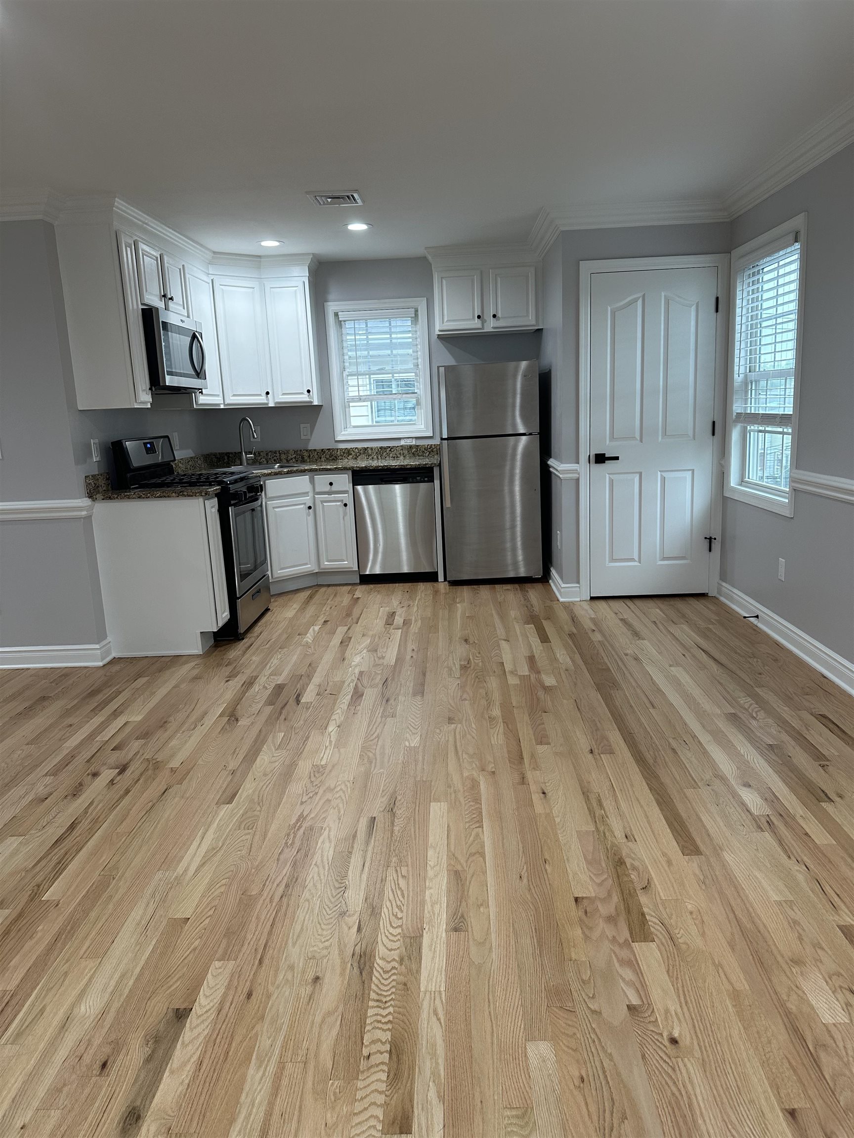 24 New Street, Unit 2 Bayonne, NJ 07002 - Photo 7 of 21 a view of kitchen with refrigerator sink and cabinets