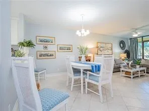 a living room with furniture and a dining table