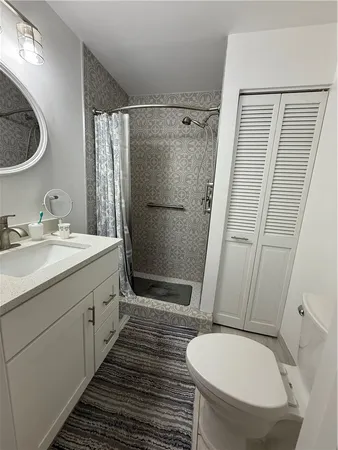 a bedroom with a bed couch and a window