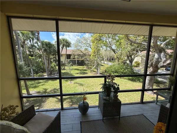 a living room with furniture a flat screen tv and a view of kitchen
