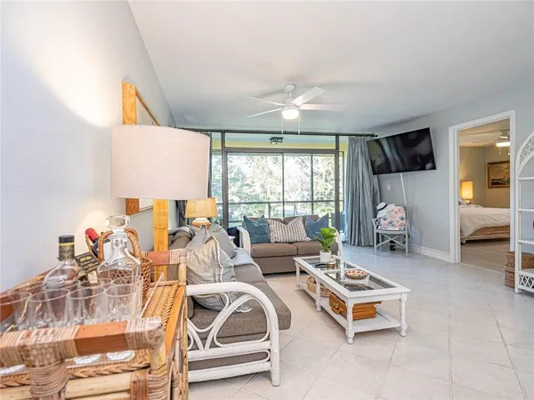 a living room with furniture a table and a large window