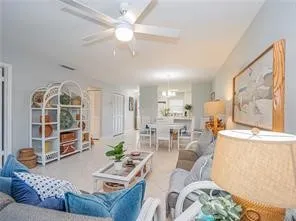 a living room with furniture a table and a large window