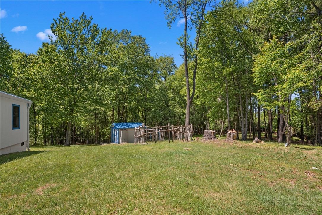 154 Folger Road Sparta, NC 28675 - Photo 15 of 37 a view of house with trees in background