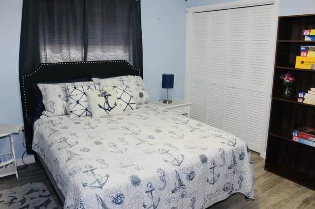 a bedroom with a bed and a night stand