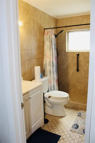 a bathroom with a toilet sink and shower