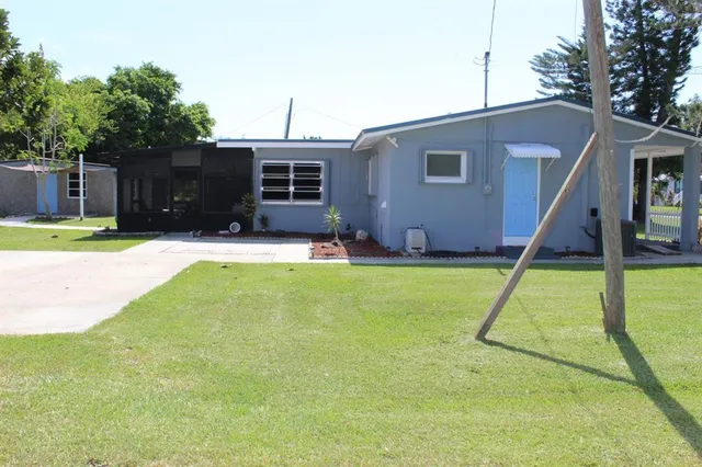 a house that has a big yard with wooden fence