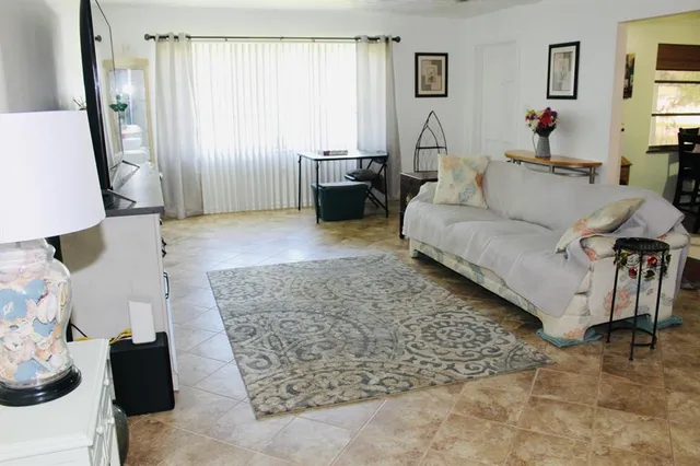 a living room with furniture and a rug