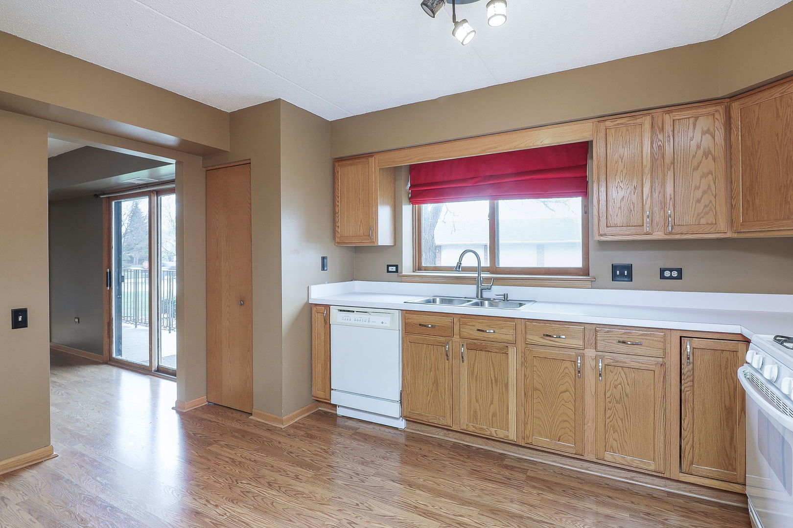 18100 Rita Road, Unit 1B Tinley Park, IL 60477 - Photo 12 of 21 a kitchen with a sink cabinets and window