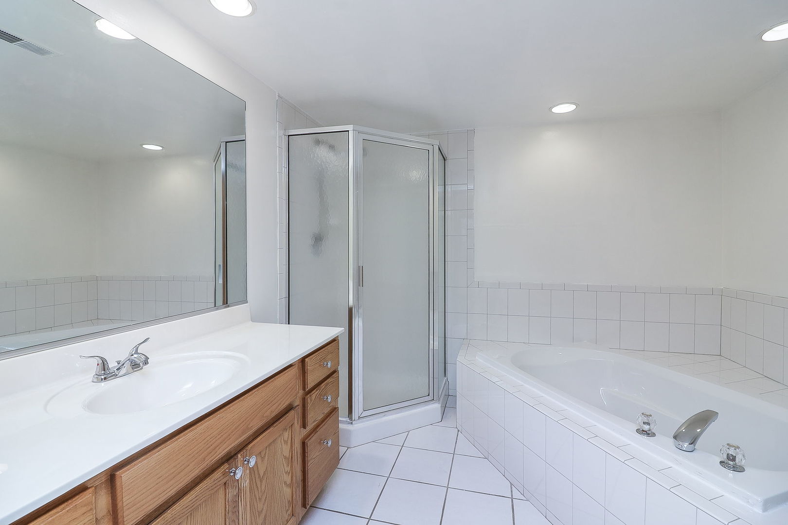 18100 Rita Road, Unit 1B Tinley Park, IL 60477 - Photo 15 of 21 a bathroom with a tub sink double vanity and tub