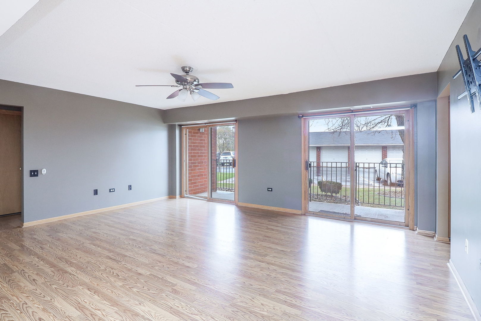 18100 Rita Road, Unit 1B Tinley Park, IL 60477 - Photo 6 of 21 a view of an empty room with window and wooden floor