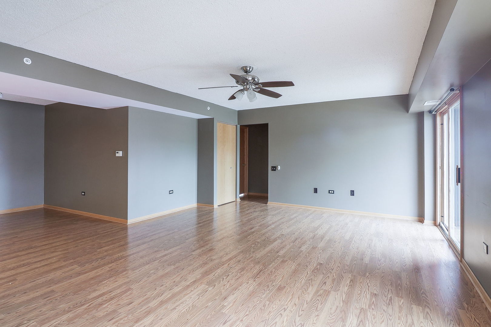 18100 Rita Road, Unit 1B Tinley Park, IL 60477 - Photo 7 of 21 wooden floor in an empty room with a window