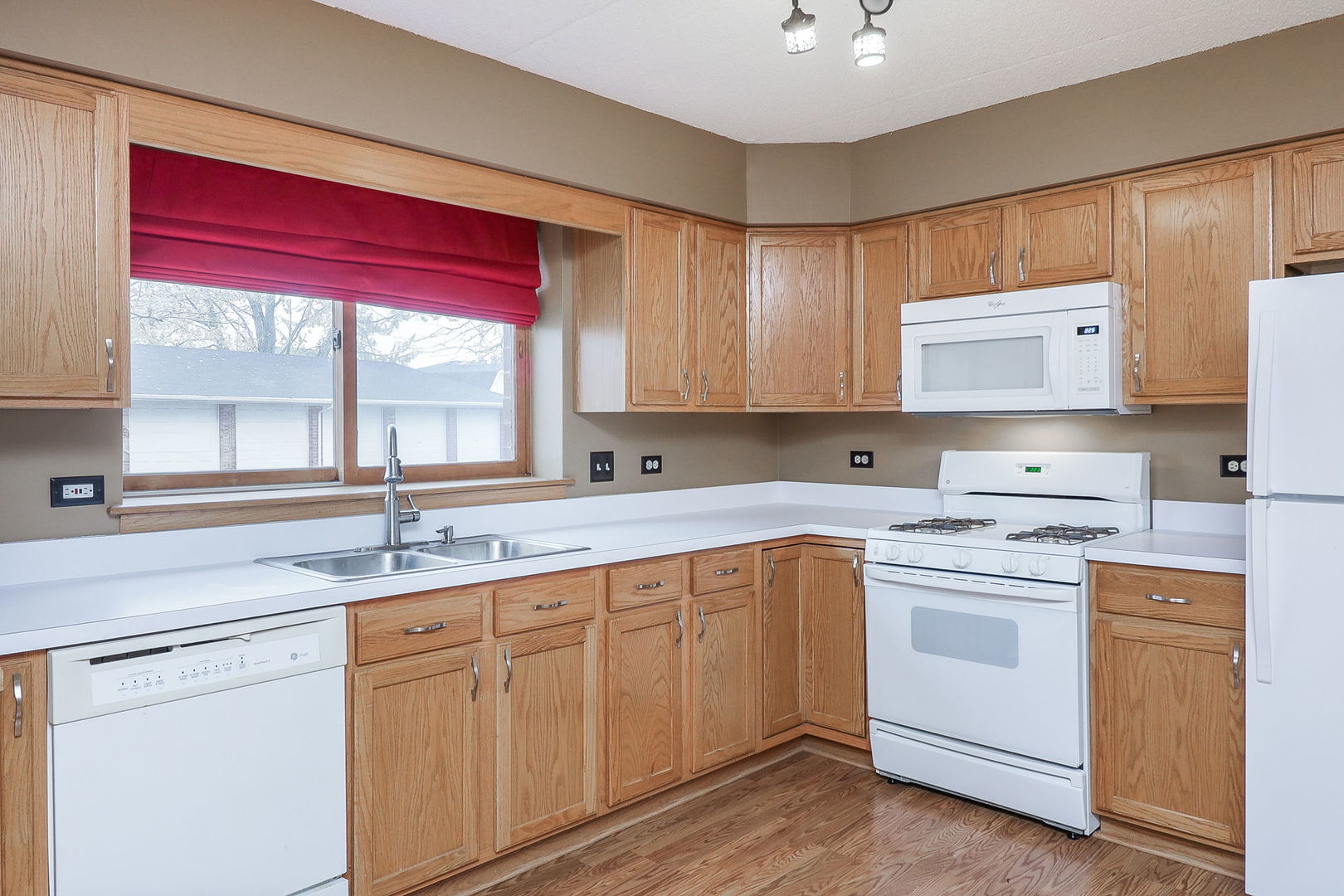 18100 Rita Road, Unit 1B Tinley Park, IL 60477 - Photo 10 of 21 a kitchen with a sink stove and cabinets