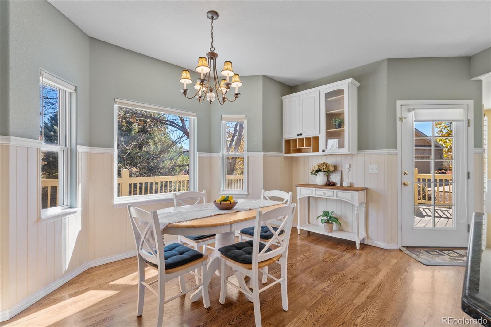 1356 Northpark Drive Lafayette, CO 80026 - Photo 11 of 35 a view of a dining room with furniture a chandelier and wooden floor