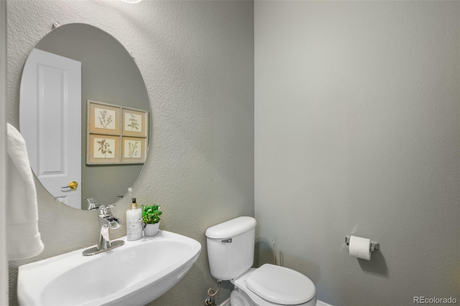 1356 Northpark Drive Lafayette, CO 80026 - Photo 15 of 35 a bathroom with a toilet a sink and a mirror