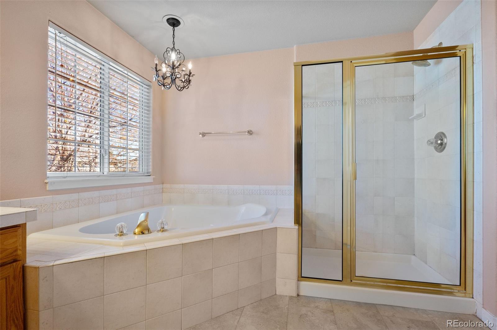 1356 Northpark Drive Lafayette, CO 80026 - Photo 17 of 35 a bathroom with a bathtub and a shower