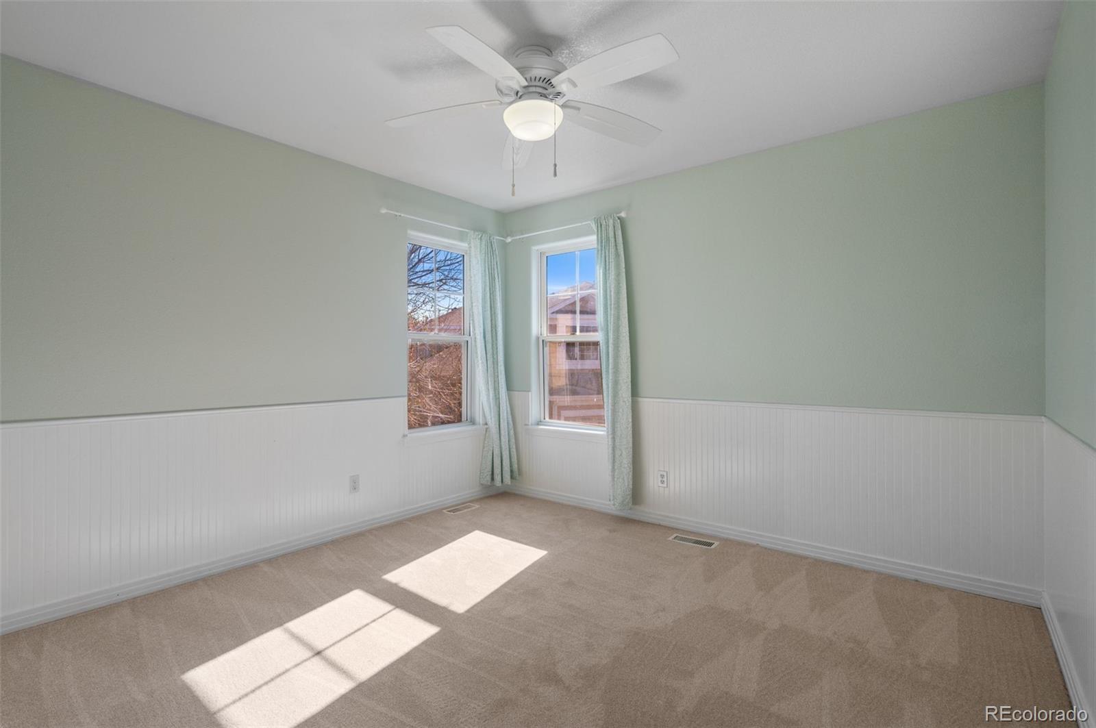 1356 Northpark Drive Lafayette, CO 80026 - Photo 19 of 35 an empty room with windows and fan
