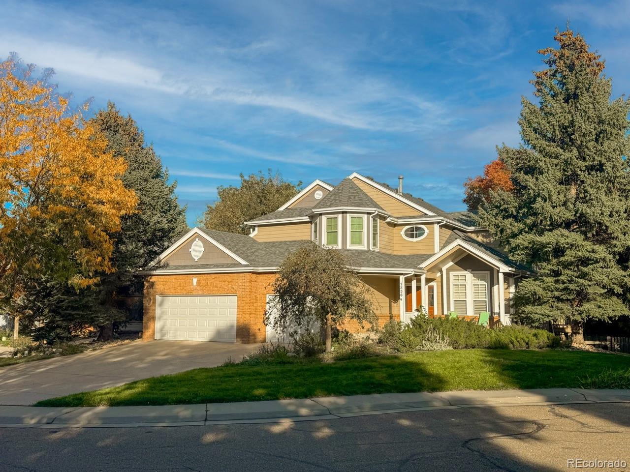 1356 Northpark Drive Lafayette, CO 80026 - Photo 2 of 35 a front view of a house with a yard and garage