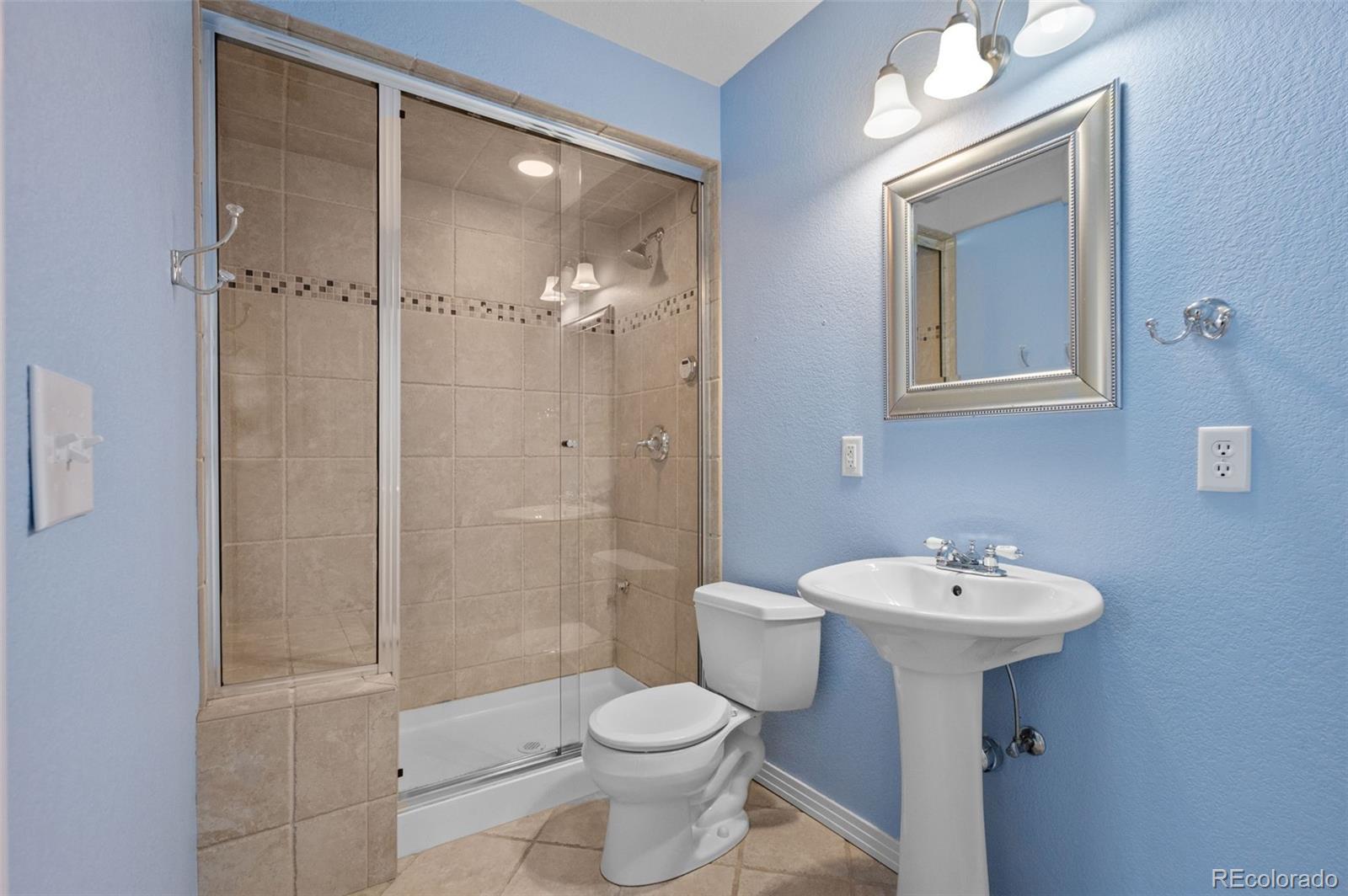 1356 Northpark Drive Lafayette, CO 80026 - Photo 23 of 35 a bathroom with a sink toilet and shower