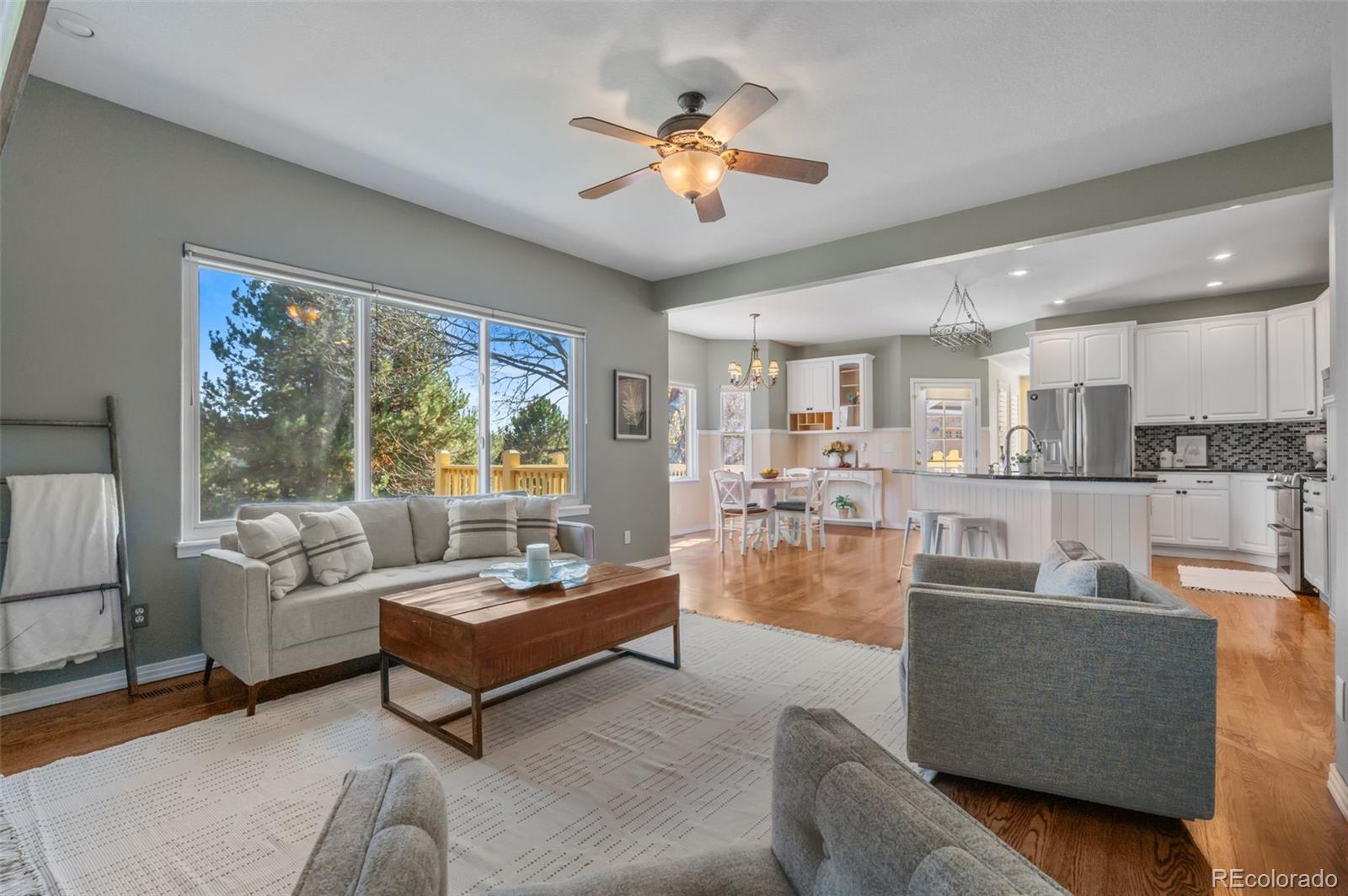 1356 Northpark Drive Lafayette, CO 80026 - Photo 10 of 35 a living room with furniture and a large window with kitchen view