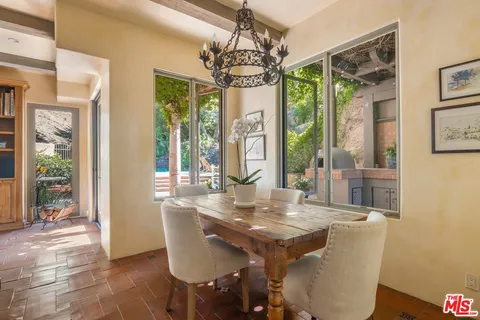 a kitchen with a stove and a wooden floor