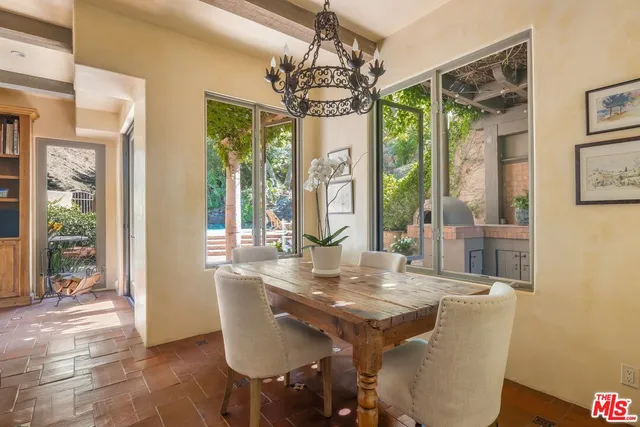 a kitchen with a stove and a wooden floor