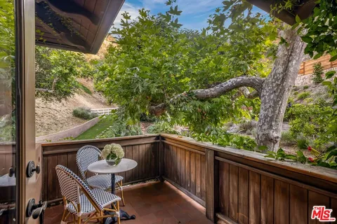 a view of a backyard with plants and outdoor seating