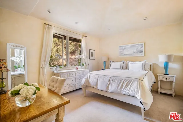 a work room with furniture and a large window