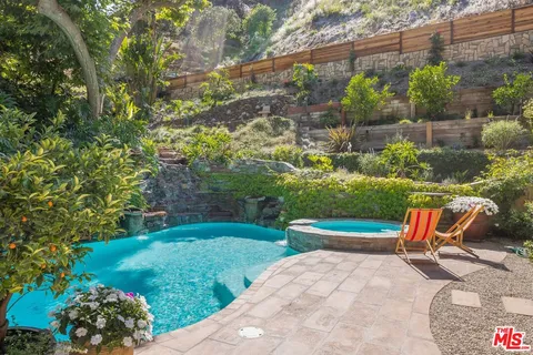 a backyard of a house with a yard and outdoor seating