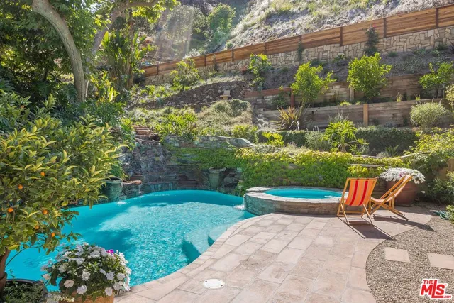 a backyard of a house with a yard and outdoor seating