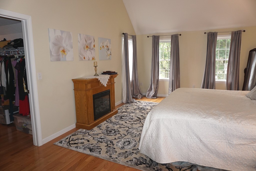84 Fairview Park Road Sturbridge, MA 01566 - Photo 16 of 30 a bedroom with a bed and a dresser with wooden floor