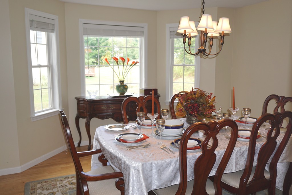 84 Fairview Park Road Sturbridge, MA 01566 - Photo 8 of 30 a view of a dining room with furniture a chandelier and wooden floor