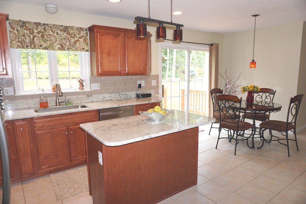 84 Fairview Park Road Sturbridge, MA 01566 - Photo 9 of 30 a kitchen with stainless steel appliances granite countertop a sink a counter top space and living room view