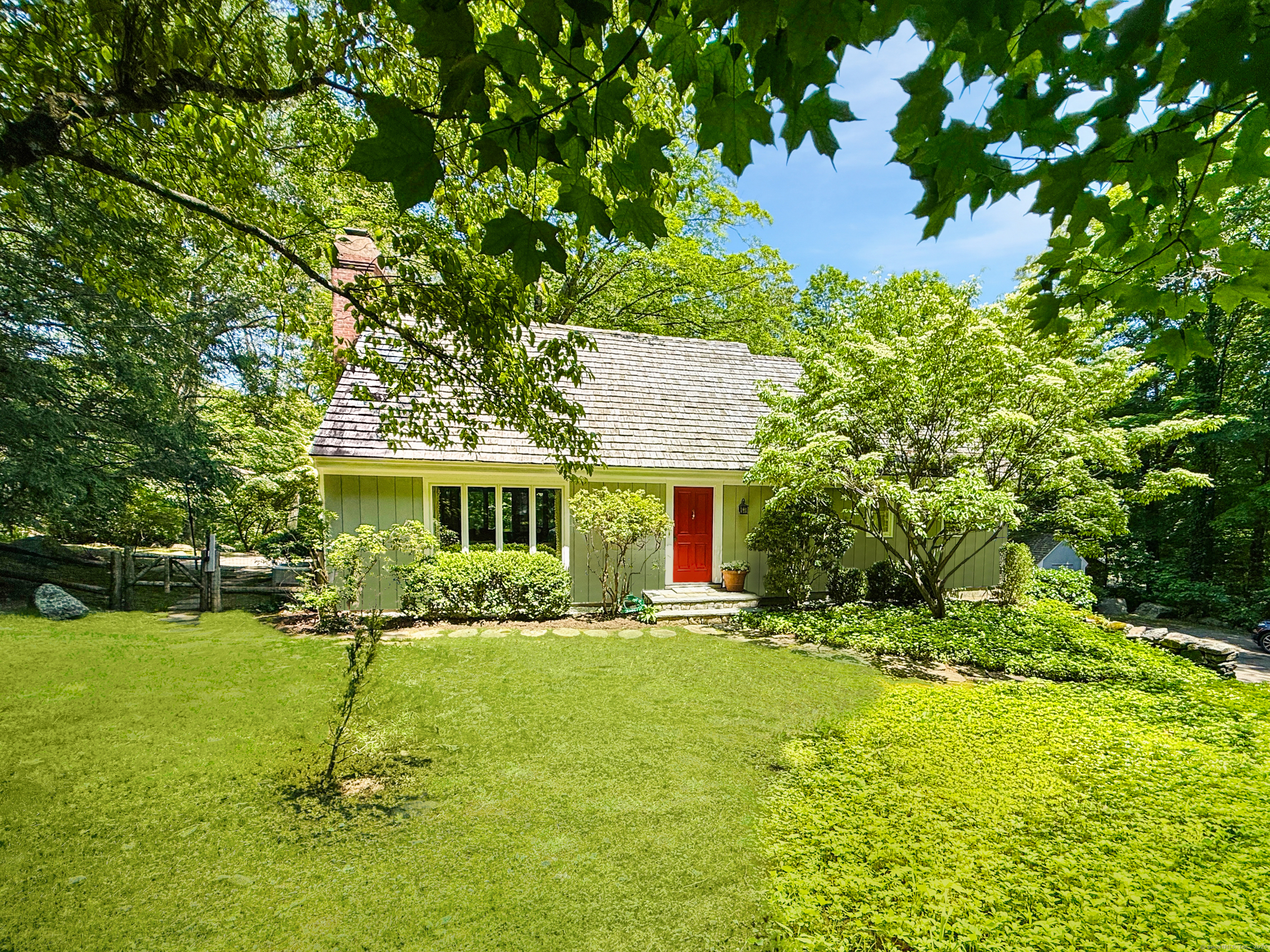 477 Woodbine Road Stamford, CT 06903 - Photo 1 of 1 a front view of house with yard and green space