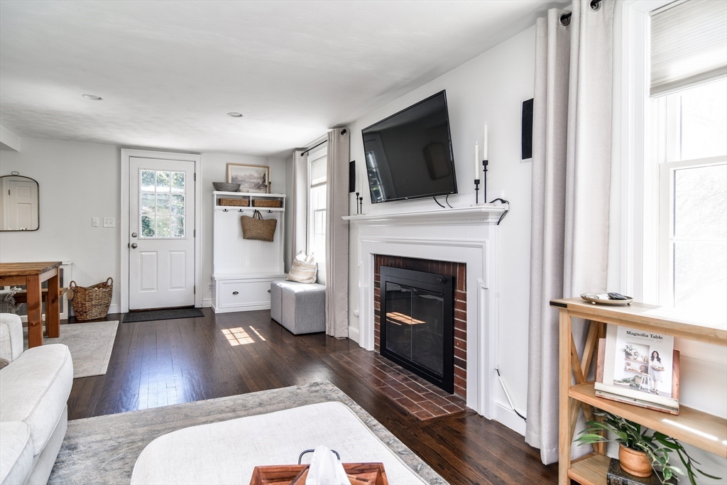 52 Wesley Road Framingham, MA 01701 - Photo 5 of 29 a living room with furniture a flat screen tv and a fireplace