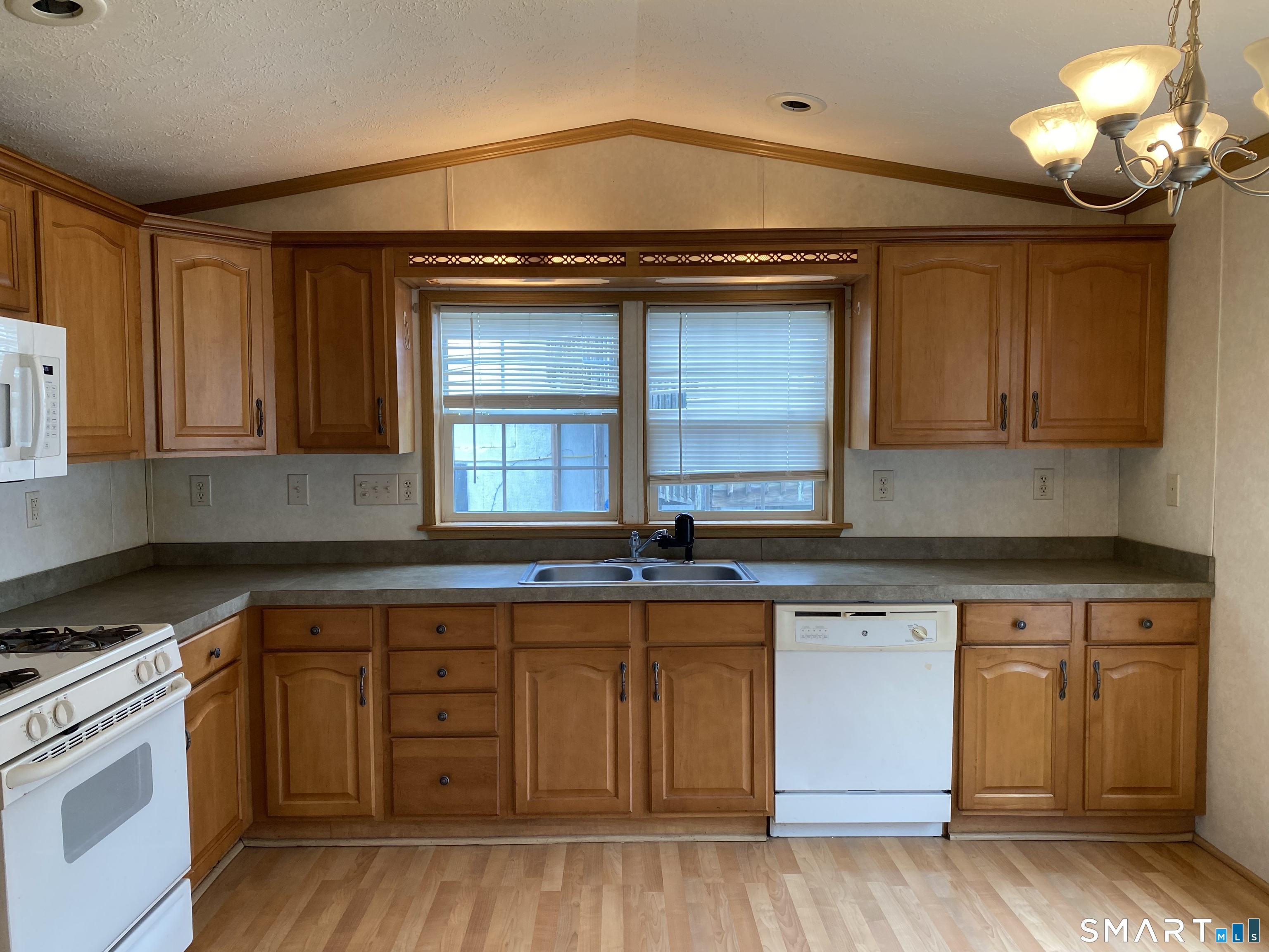 34 Terrace Drive Waterford, CT 06385 - Photo 2 of 8 a kitchen with granite countertop a stove cabinets and wooden floor