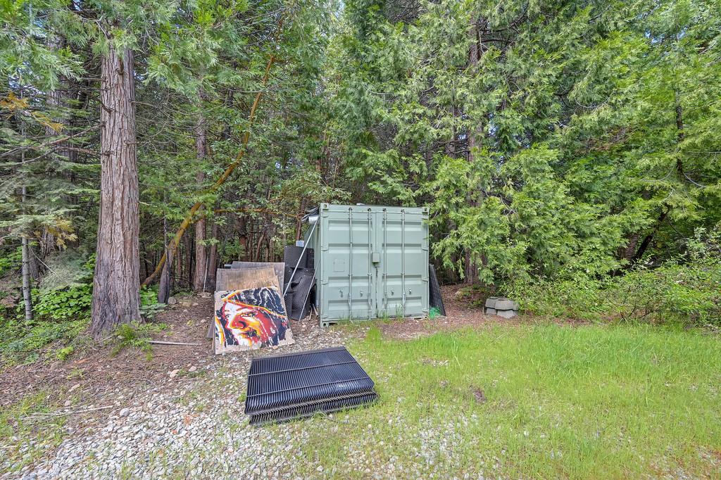 1535 Derbec Road Nevada City, CA 95959 - Photo 16 of 39 a backyard of a house with dishwasher and wooden fence