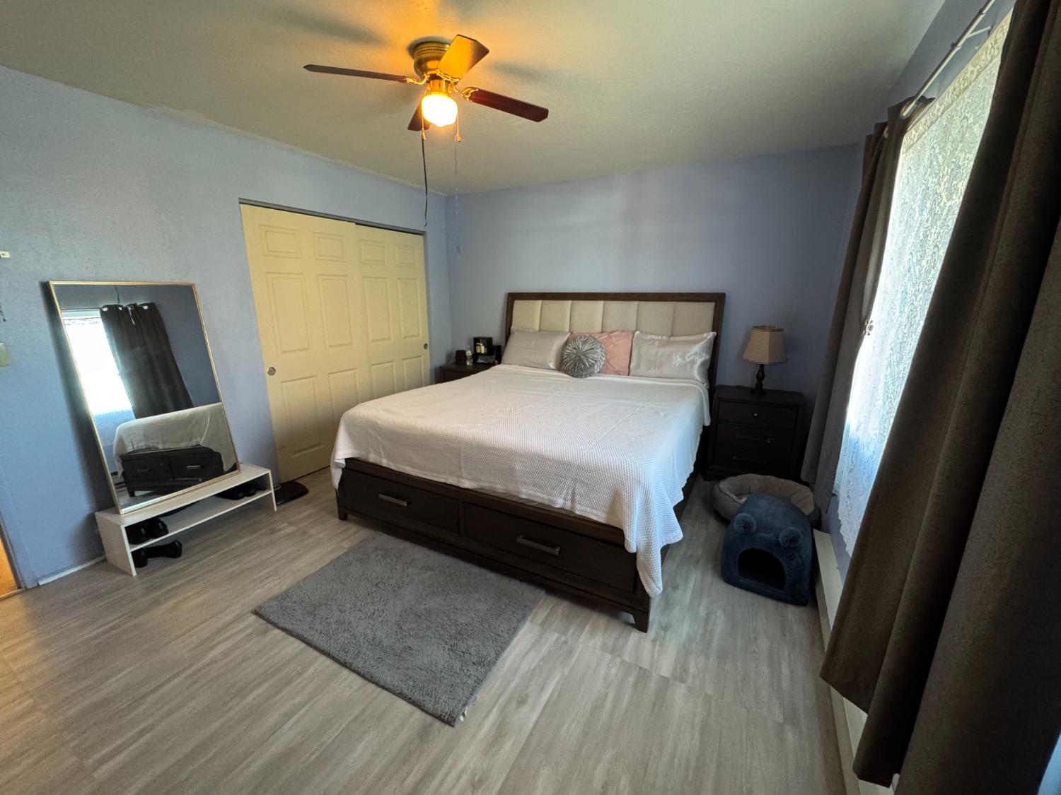 100 Patterson Avenue Loyalton, CA 96118 - Photo 16 of 36 a bedroom with a bed a mirror on dresser and a wooden floor